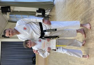 Jack receives his 7th Kyu award from Sensei Damon