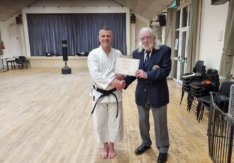 Damon receives his 4th Dan award from Sensei Reg